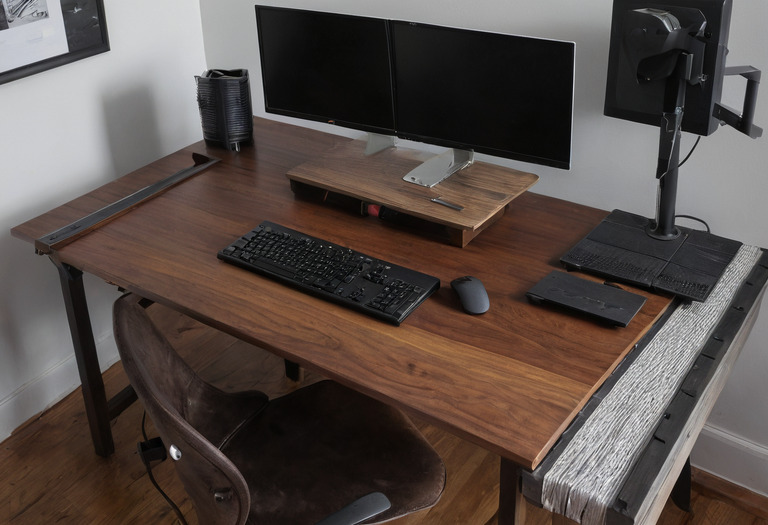 Overhead view of a monitor, keyboard and cable zone on a deep desk