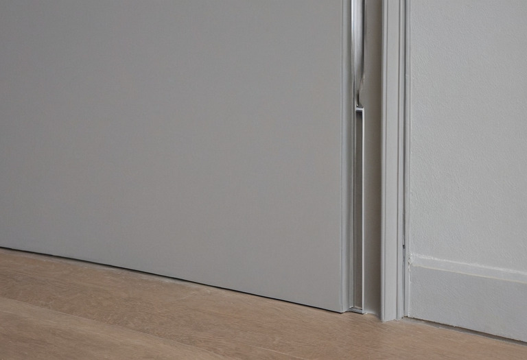 Close view of a flush painted door with concealed frame and consistent perimeter reveal