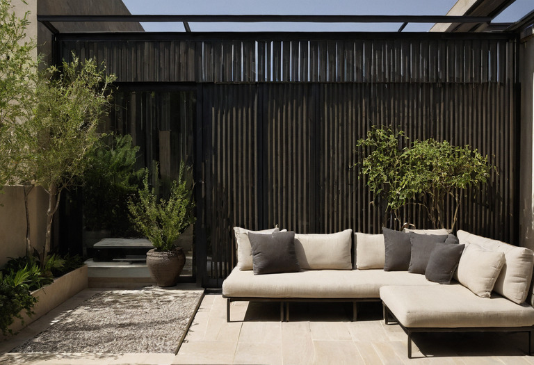 Outdoor seating beneath a deep canopy with measured afternoon shade