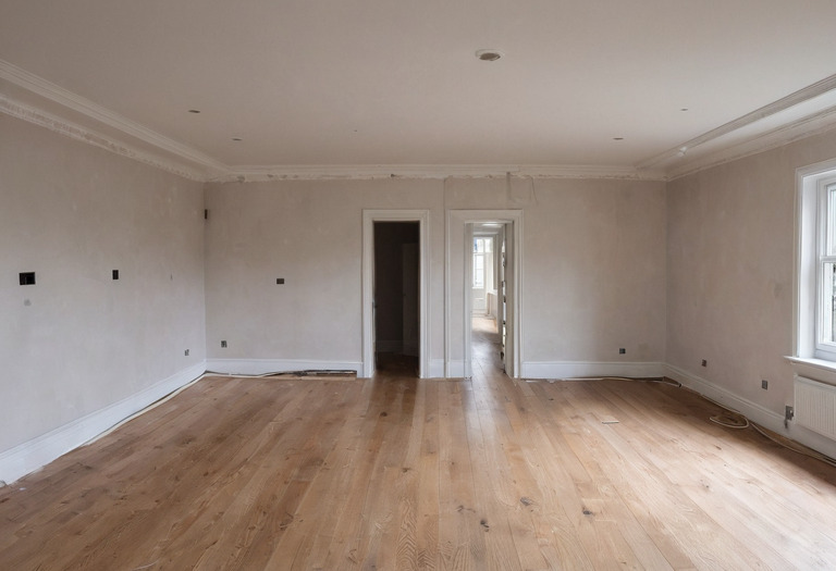 Partly renovated living room with open wall boxes, ceiling cables and a finished control keypad sample