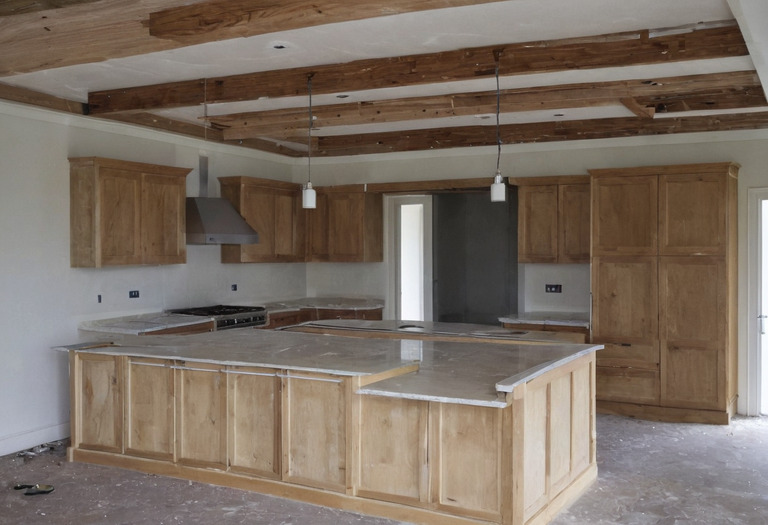 Three pendant cables aligned over a kitchen island before final trimming