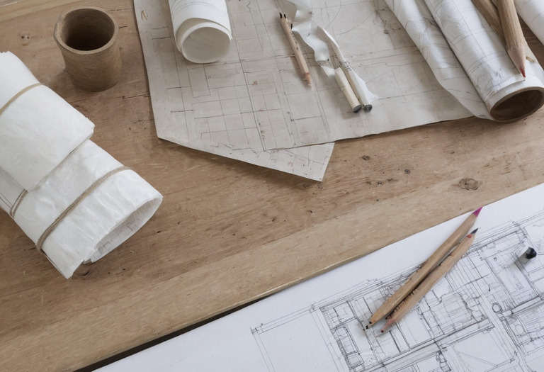 Interior design project table with plans, finish samples, schedules, and a scale ruler