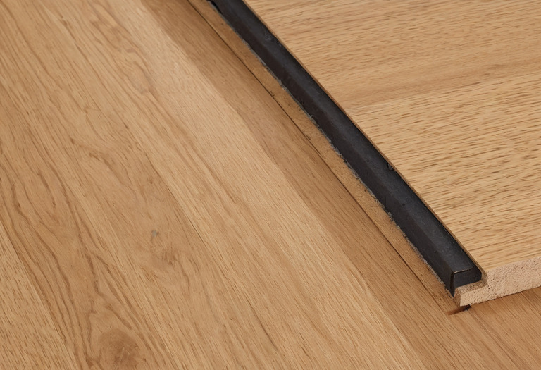 Close view of engineered oak boards and a small seasonal joint gap